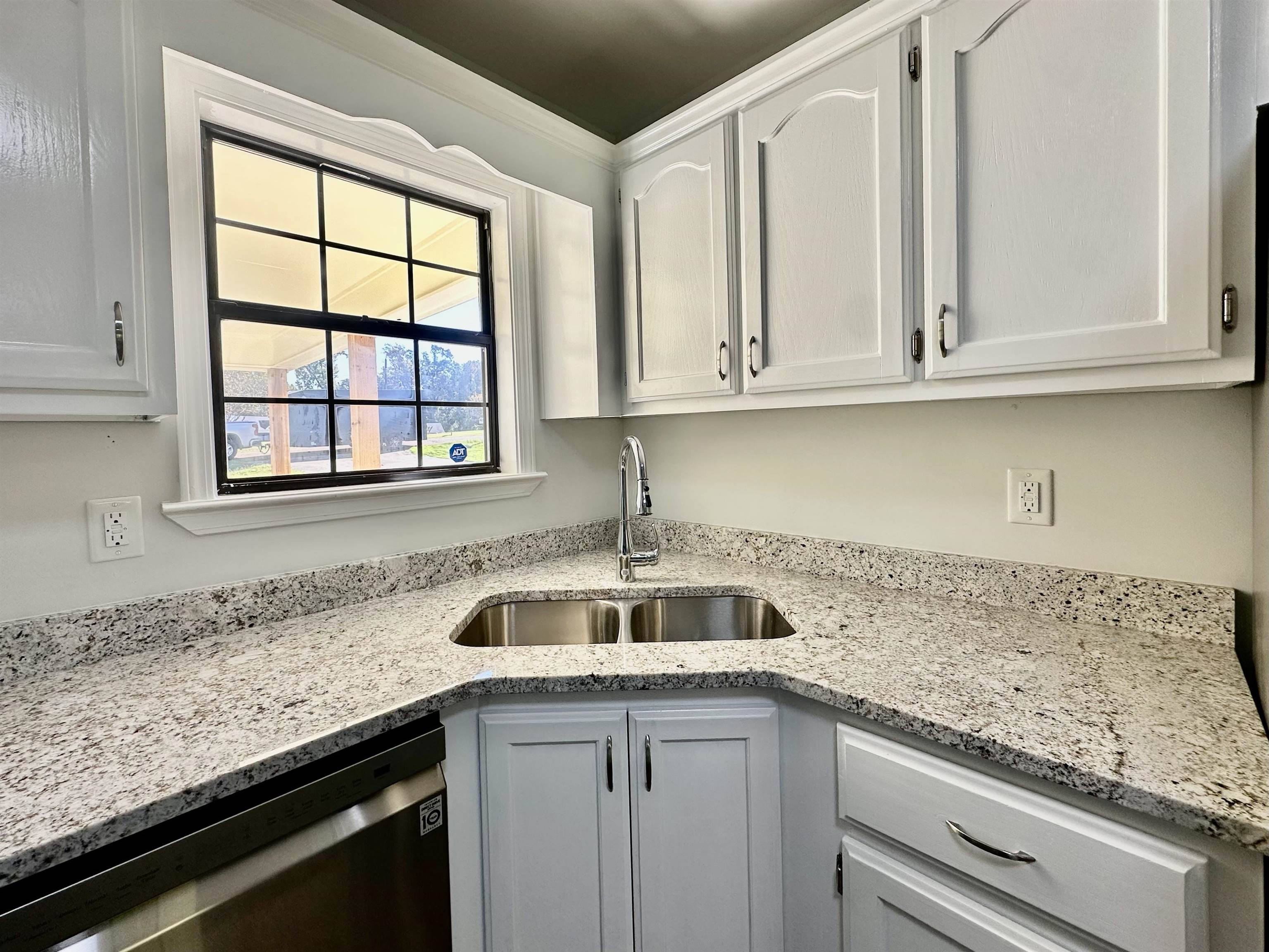 249 Mignon Road Atoka, TN 38004 - Photo 14 of 28 Kitchen with light stone counters, stainless steel dishwasher, and white cabinets