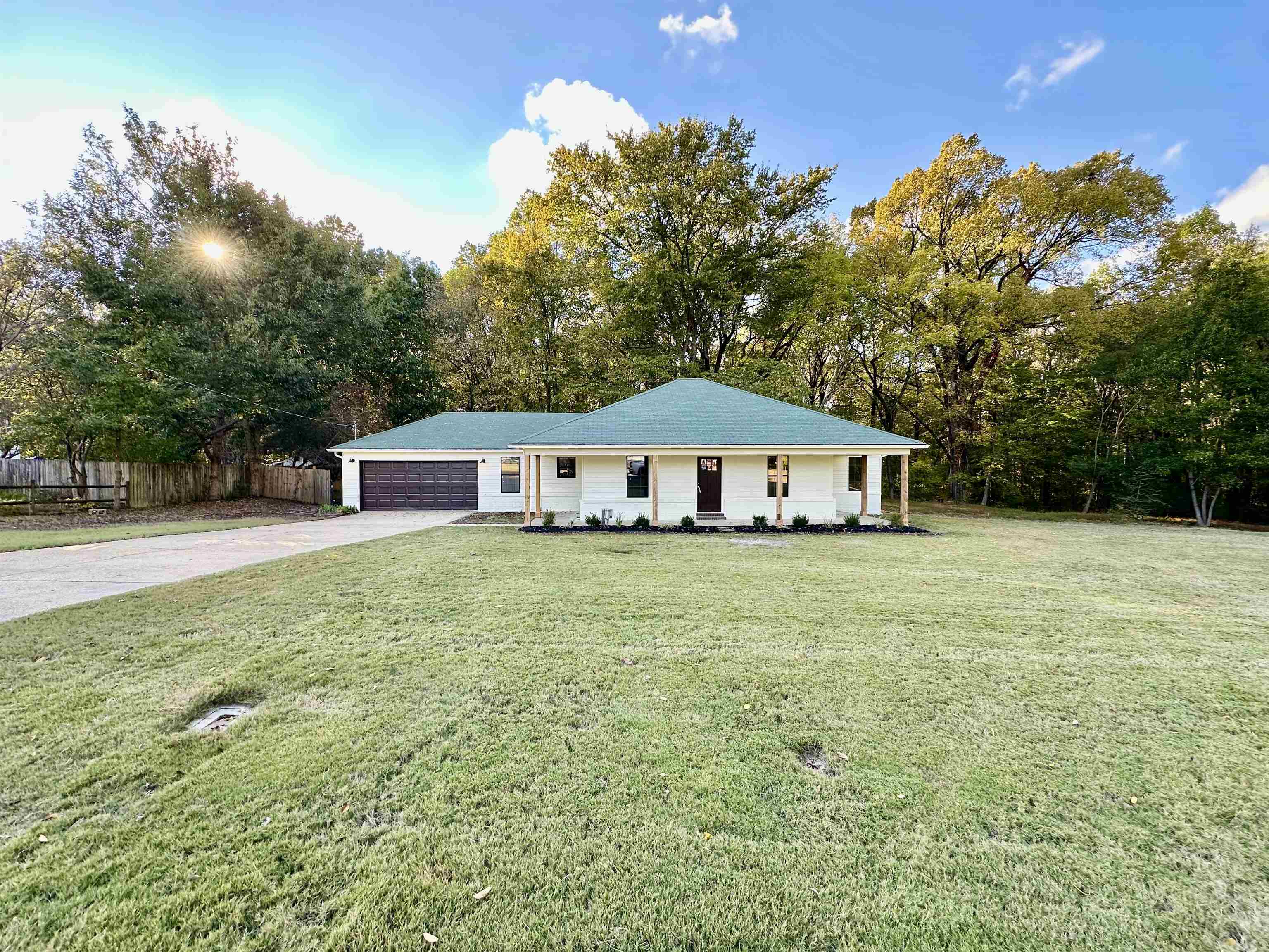 249 Mignon Road Atoka, TN 38004 - Photo 3 of 28 Ranch-style house featuring driveway, an attached garage, and a porch
