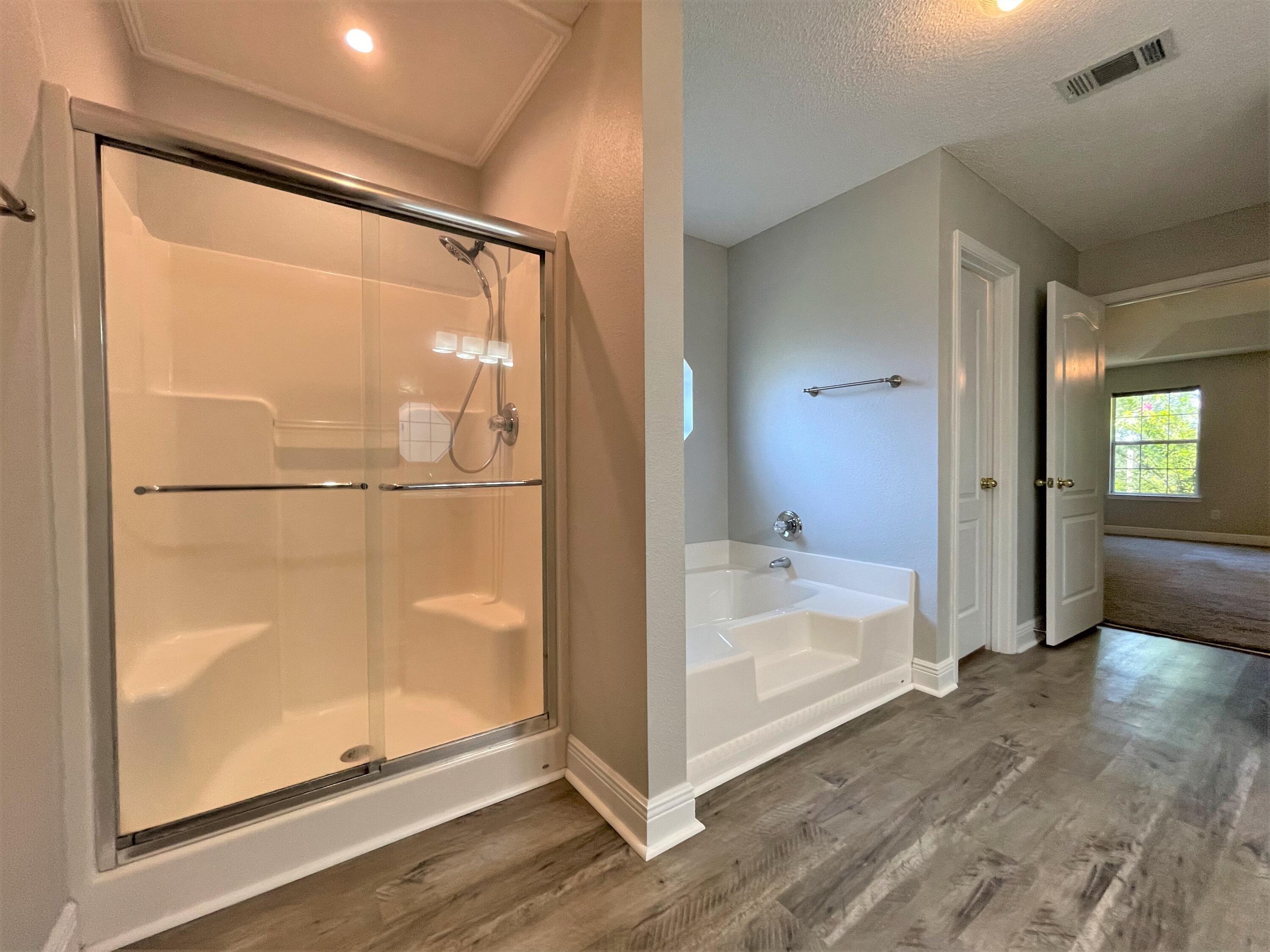 711 Fennec Fox Preserve Crestview, FL 32536 - Photo 18 of 33 a bathroom with a glass shower door