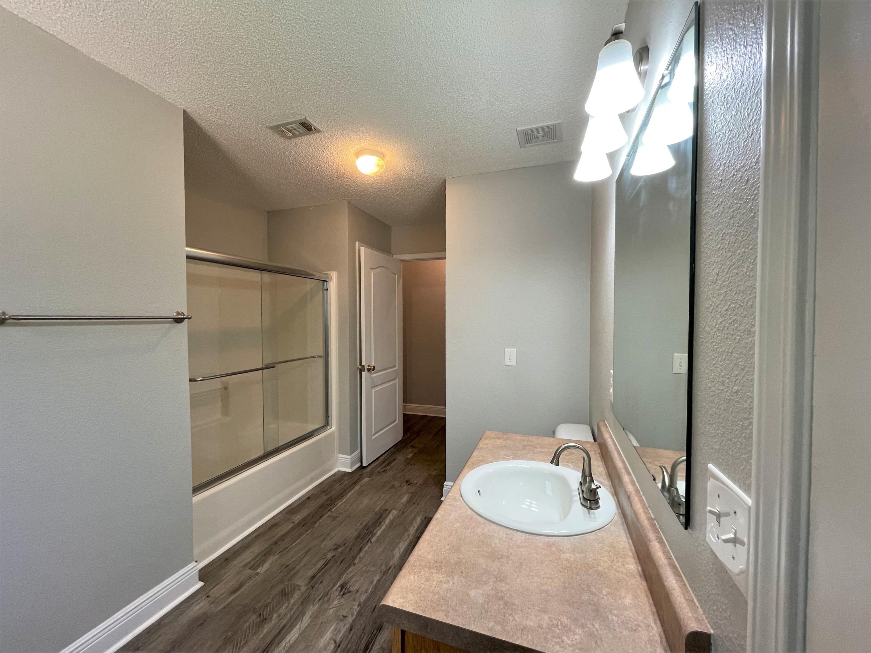 711 Fennec Fox Preserve Crestview, FL 32536 - Photo 25 of 33 a bathroom with a sink and a mirror