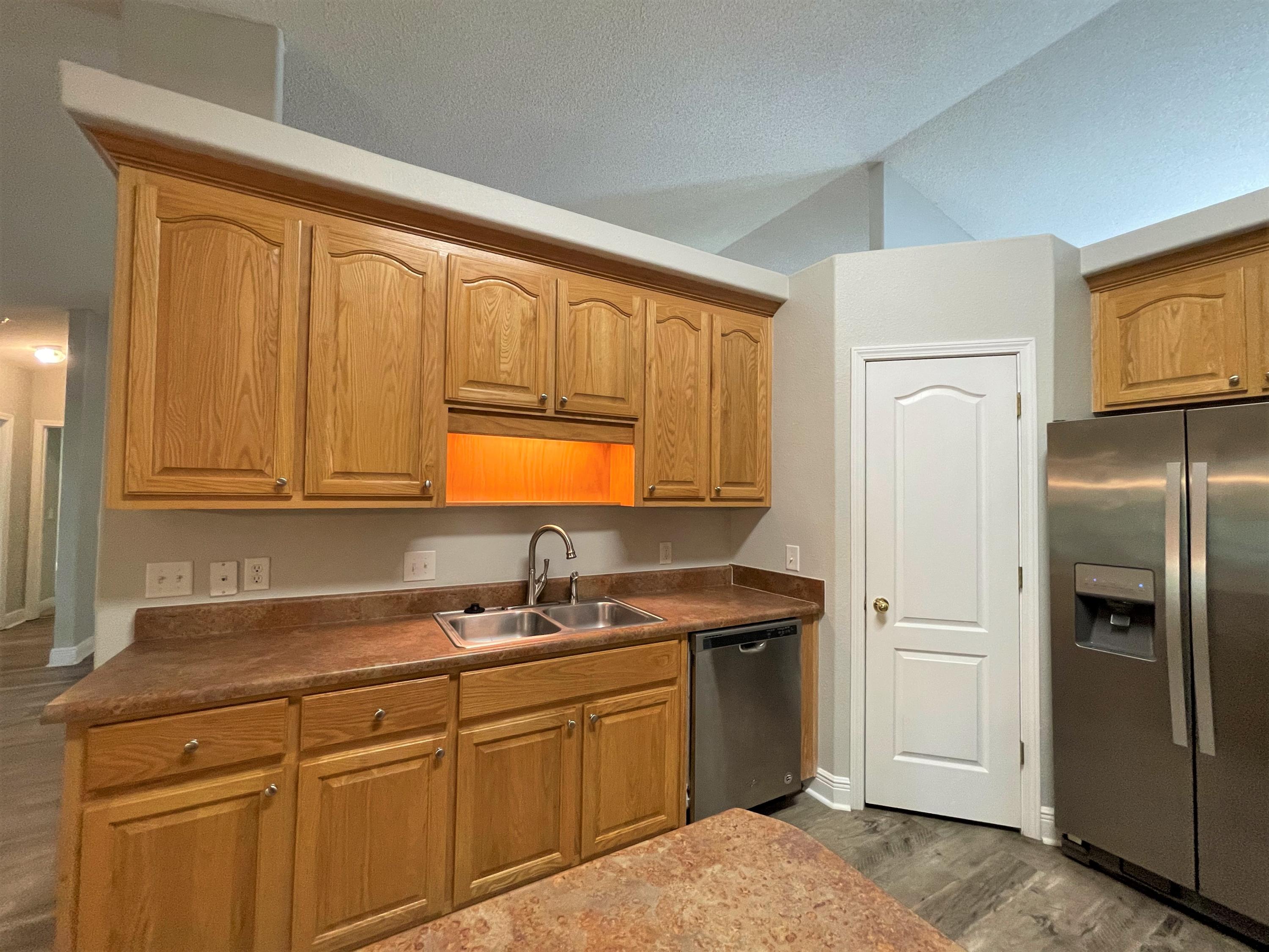711 Fennec Fox Preserve Crestview, FL 32536 - Photo 9 of 33 a kitchen with stainless steel appliances granite countertop a refrigerator sink and cabinets