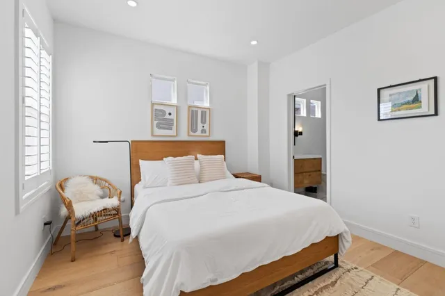 a bedroom with a bed and chair