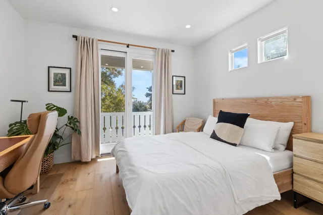 a bedroom with a bed a desk and chair