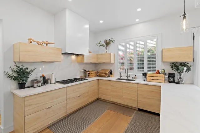 a kitchen with sink cabinets and window