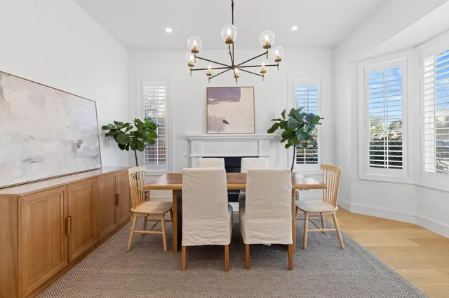 a view of a dining room with furniture and a potted plant