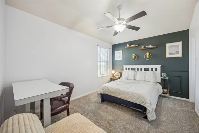 a bedroom with a bed and a table in it