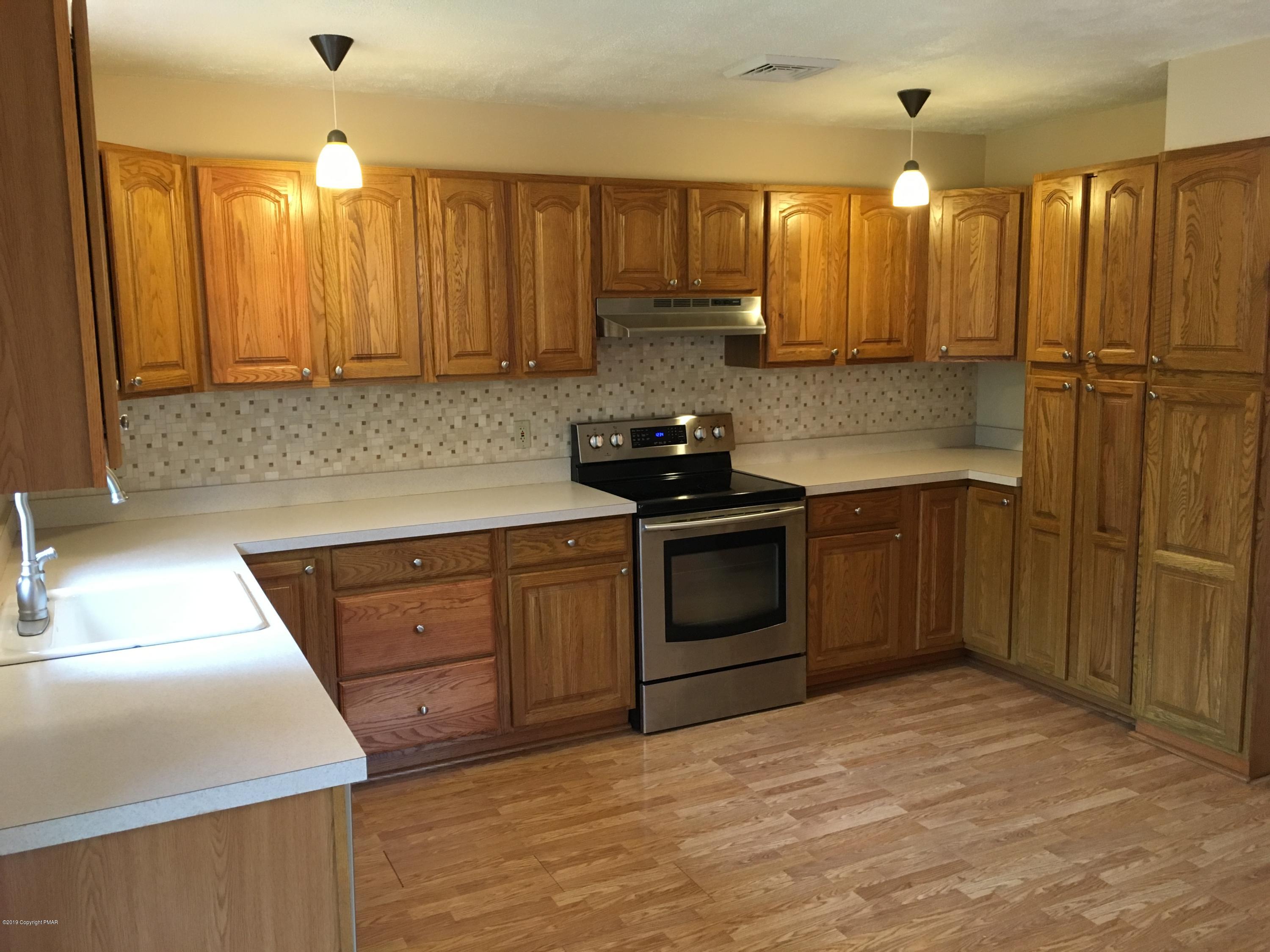 668 Cherry Lane Road East Stroudsburg, PA 18301 - Photo 18 of 28 a kitchen with stainless steel appliances granite countertop a sink a stove and a refrigerator