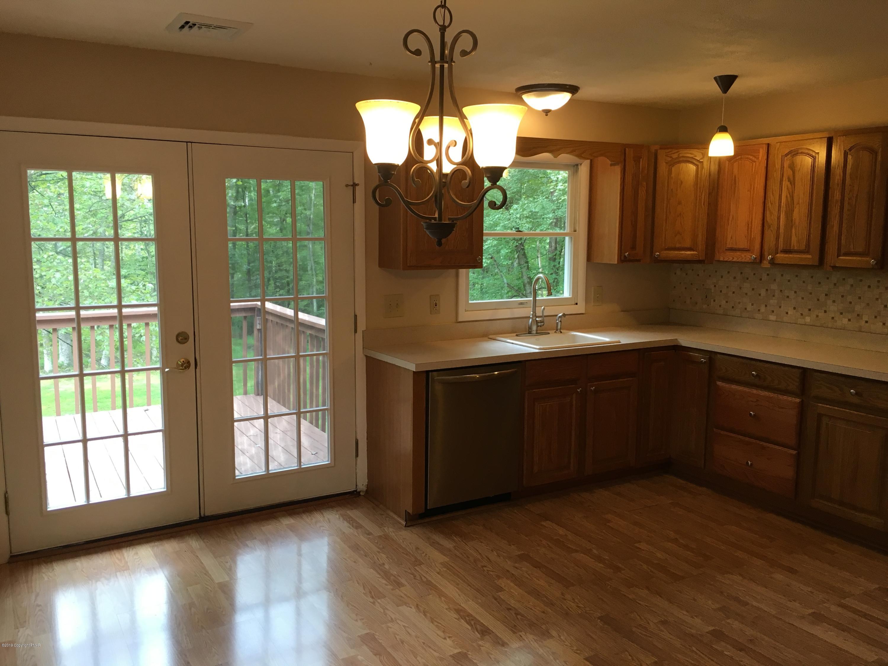 668 Cherry Lane Road East Stroudsburg, PA 18301 - Photo 19 of 28 a kitchen with kitchen island granite countertop a stove a sink and a large window