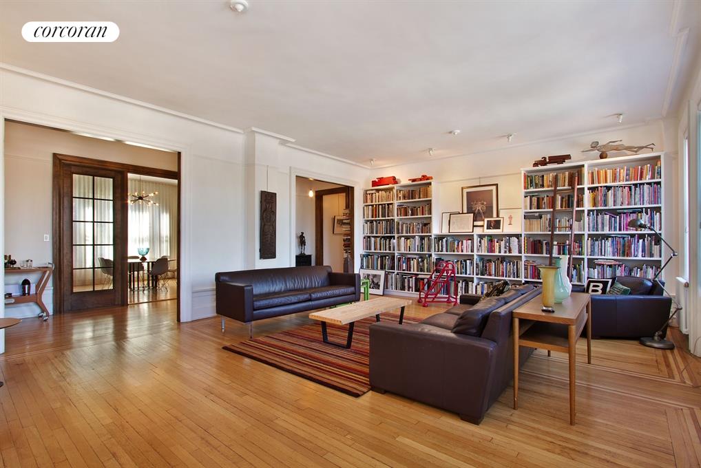 800 Riverside Drive, Unit 7E Manhattan, NY 10032 - Photo 1 of 1 a living room with furniture and a book shelf