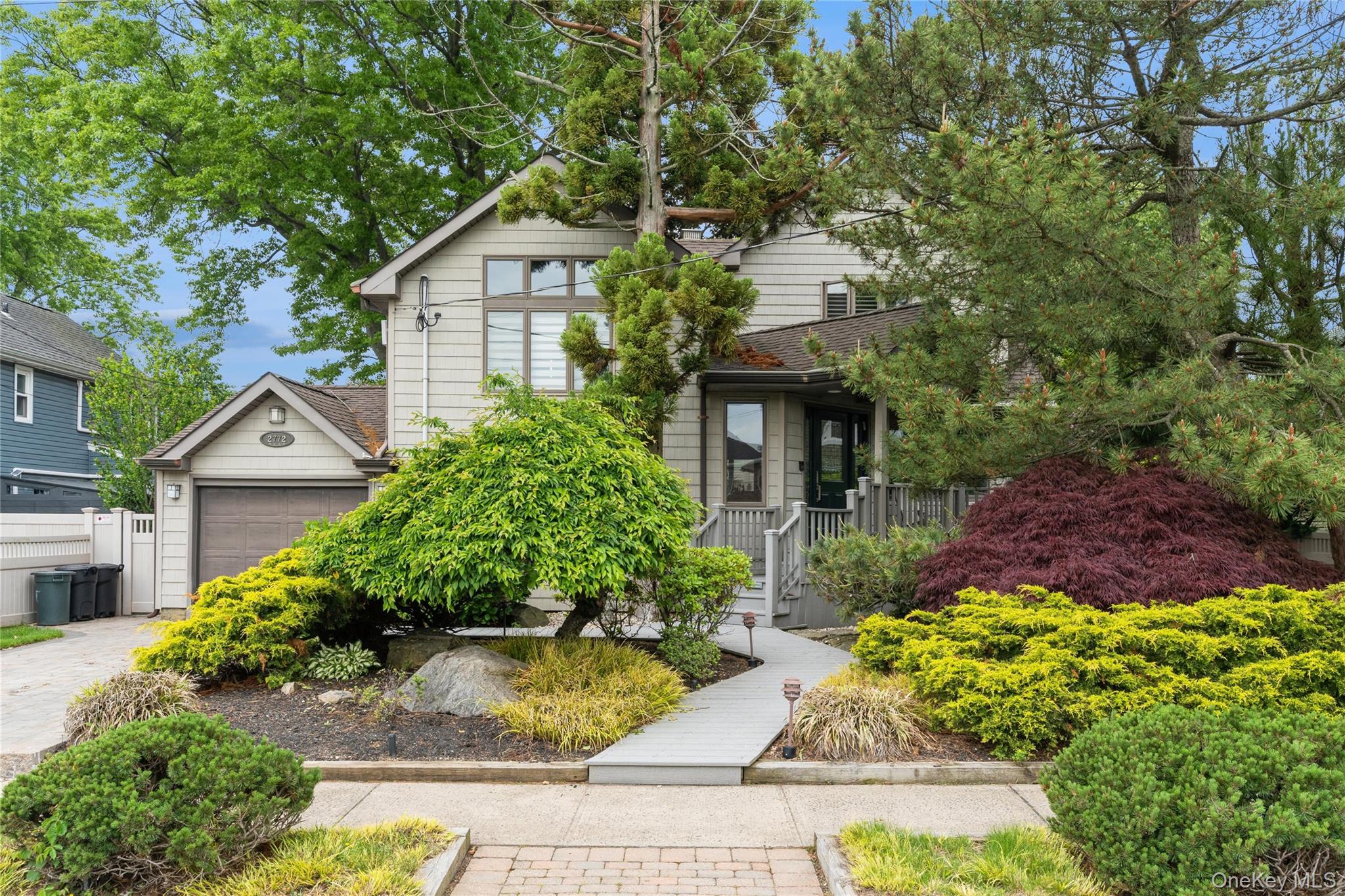 2772 Riverside Avenue Merrick, NY 11566 - Photo 41 of 45 a front view of a house with a garden