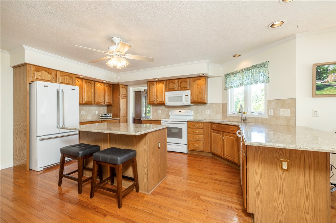 85 Sotheby Drive Greece, NY 14626 - Photo 17 of 50 BEAUTIFUL EAT-IN KITCHEN - WOOD CABINETRY & QUARTZ