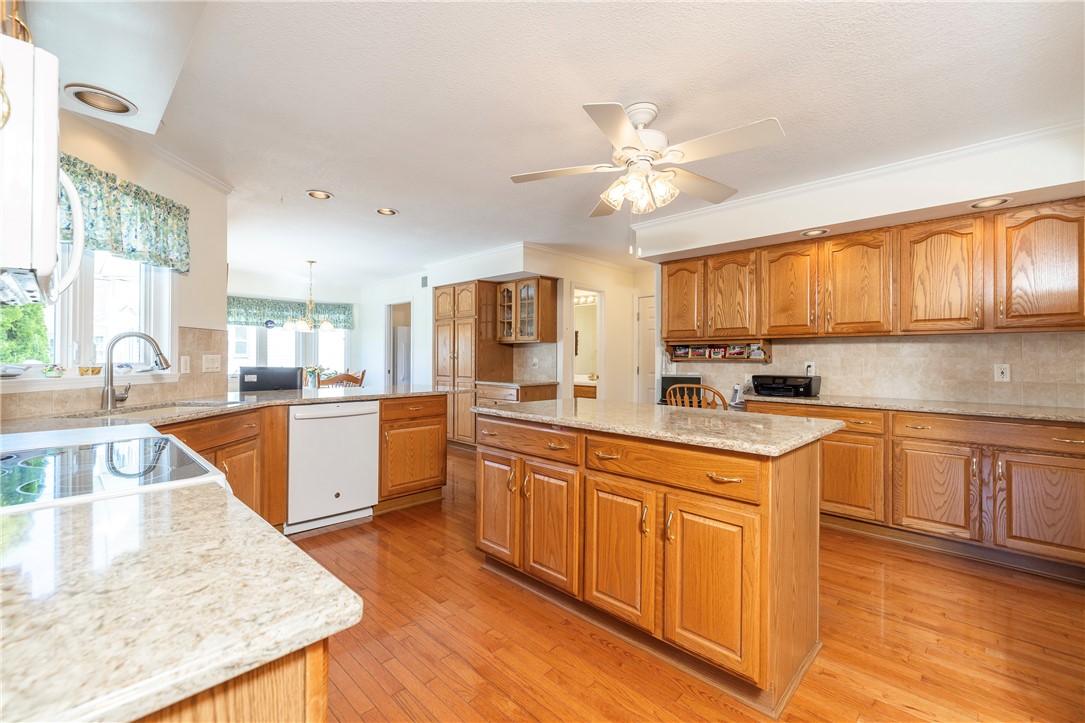 85 Sotheby Drive Greece, NY 14626 - Photo 18 of 50 BEAUTIFUL EAT-IN KITCHEN - WOOD CABINETRY & QUARTZ