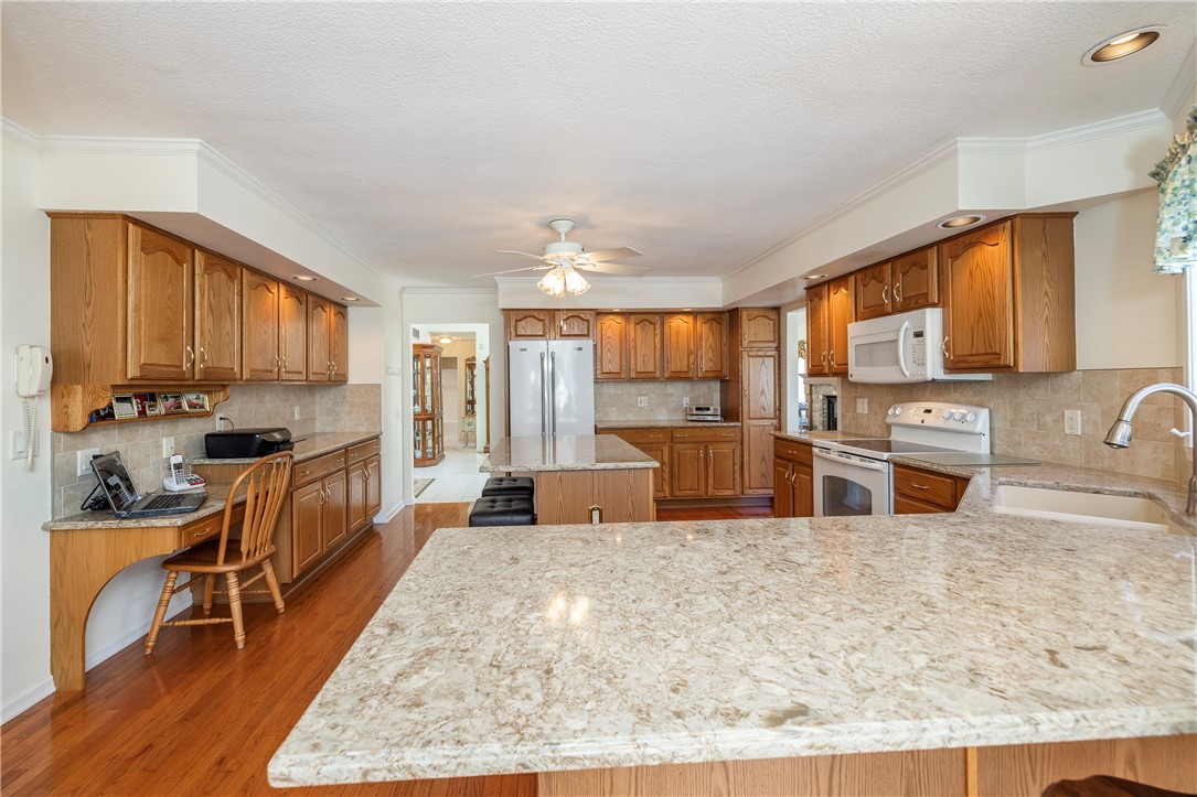 85 Sotheby Drive Greece, NY 14626 - Photo 20 of 50 BEAUTIFUL EAT-IN KITCHEN - WOOD CABINETRY & QUARTZ