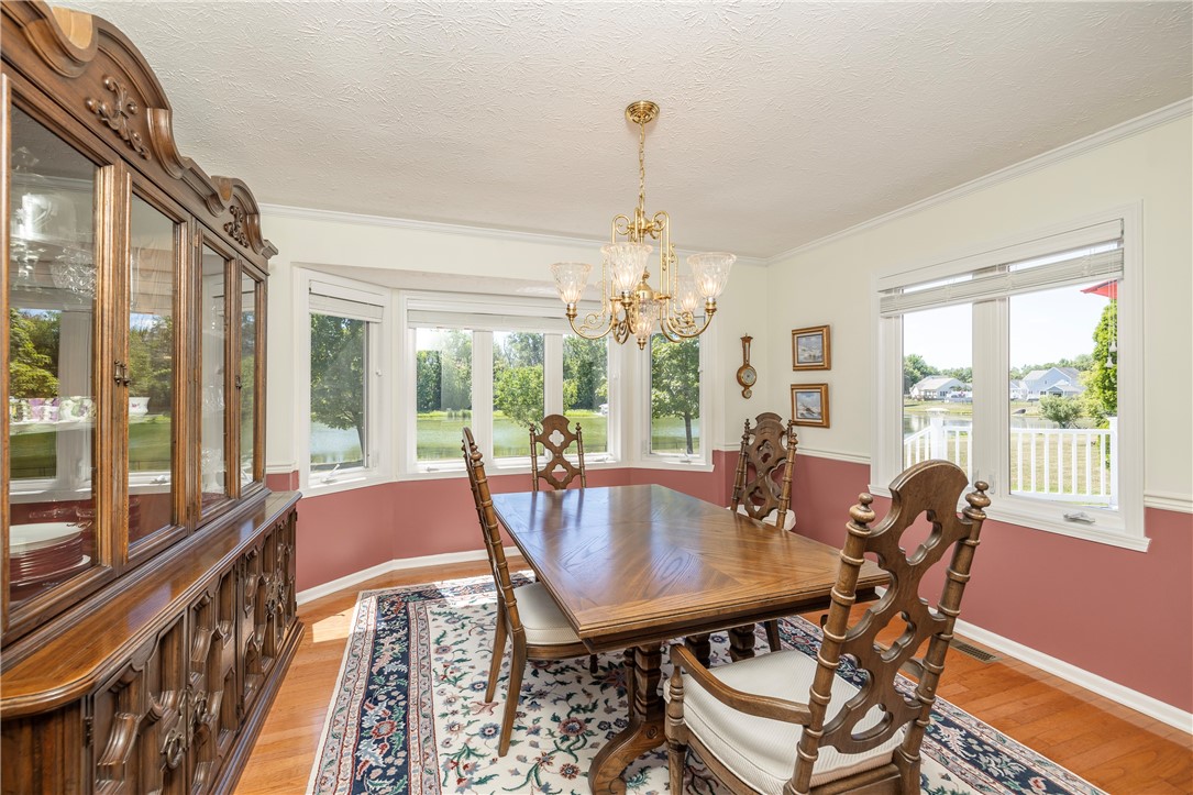 85 Sotheby Drive Greece, NY 14626 - Photo 26 of 50 FORMAL DINING ROOM WITH BOW WINDOWS & POND VIEWS