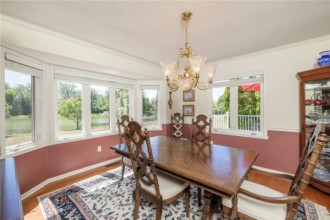 85 Sotheby Drive Greece, NY 14626 - Photo 27 of 50 FORMAL DINING ROOM WITH BOW WINDOWS & POND VIEWS