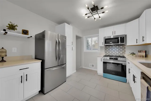 a kitchen with stainless steel appliances a refrigerator sink and microwave