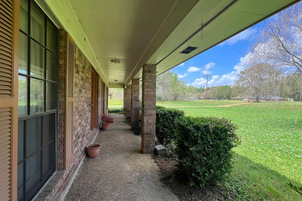 401 Cane Bend Drive Haughton, LA 71037 - Photo 2 of 12 a view of a porch with furniture and a yard