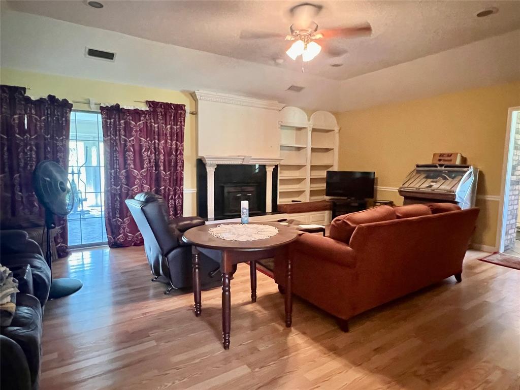 401 Cane Bend Drive Haughton, LA 71037 - Photo 3 of 12 a living room with furniture a flat screen tv and a fireplace