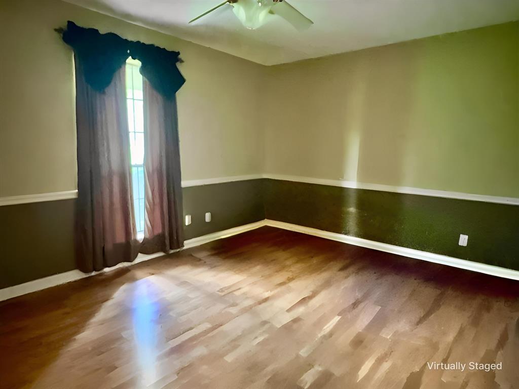 401 Cane Bend Drive Haughton, LA 71037 - Photo 8 of 12 an empty room with wooden floor and windows