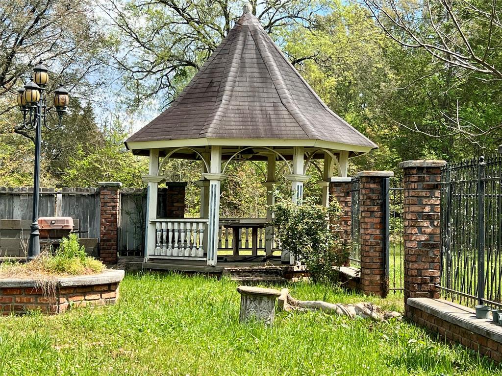 401 Cane Bend Drive Haughton, LA 71037 - Photo 9 of 12 a view of a chair and table in backyard of the house
