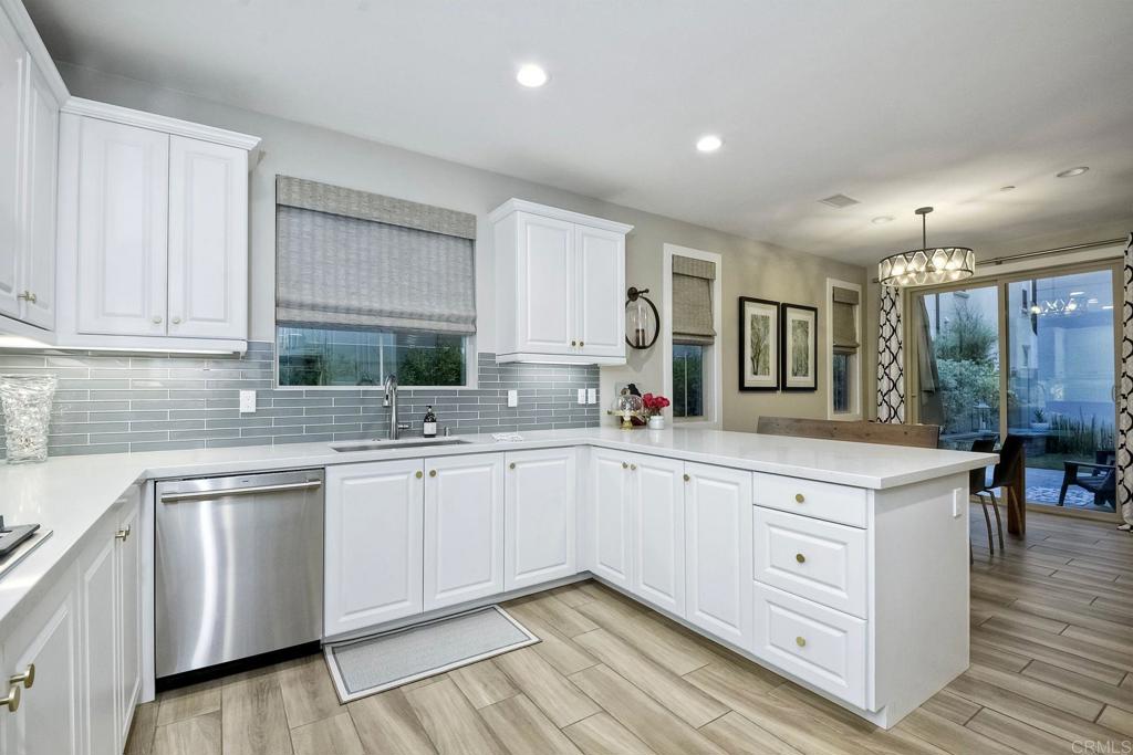 663 Gemstone Drive San Marcos, CA 92078 - Photo 13 of 38 a kitchen with white cabinets sink and white appliances
