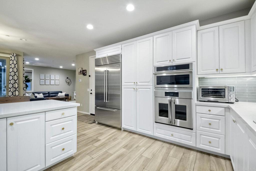 663 Gemstone Drive San Marcos, CA 92078 - Photo 14 of 38 a kitchen with stainless steel appliances a refrigerator sink and cabinets