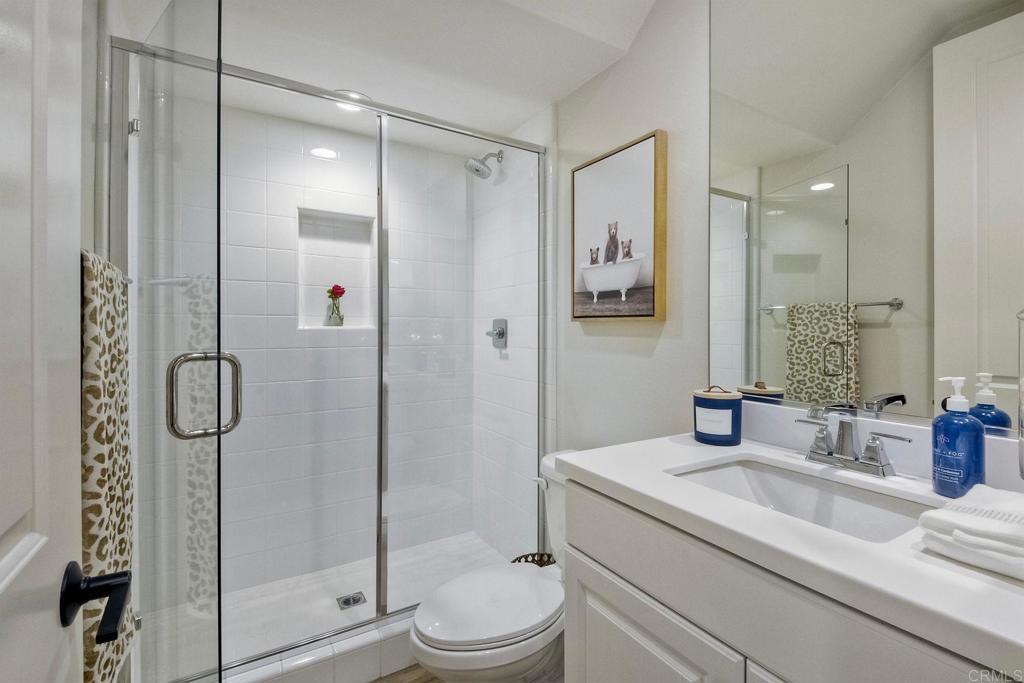 663 Gemstone Drive San Marcos, CA 92078 - Photo 15 of 38 a bathroom with a shower sink mirror and toilet
