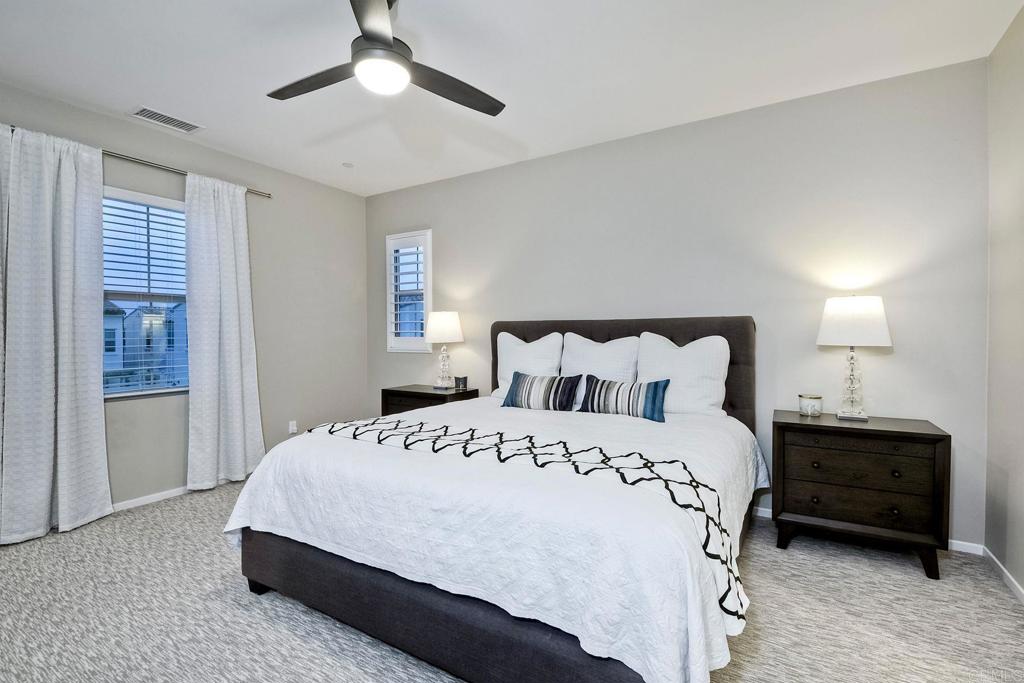 663 Gemstone Drive San Marcos, CA 92078 - Photo 20 of 38 a bedroom with a bed and a chandelier