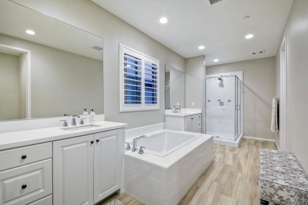 663 Gemstone Drive San Marcos, CA 92078 - Photo 21 of 38 a bathroom with a sink a toilet a large mirror and shower