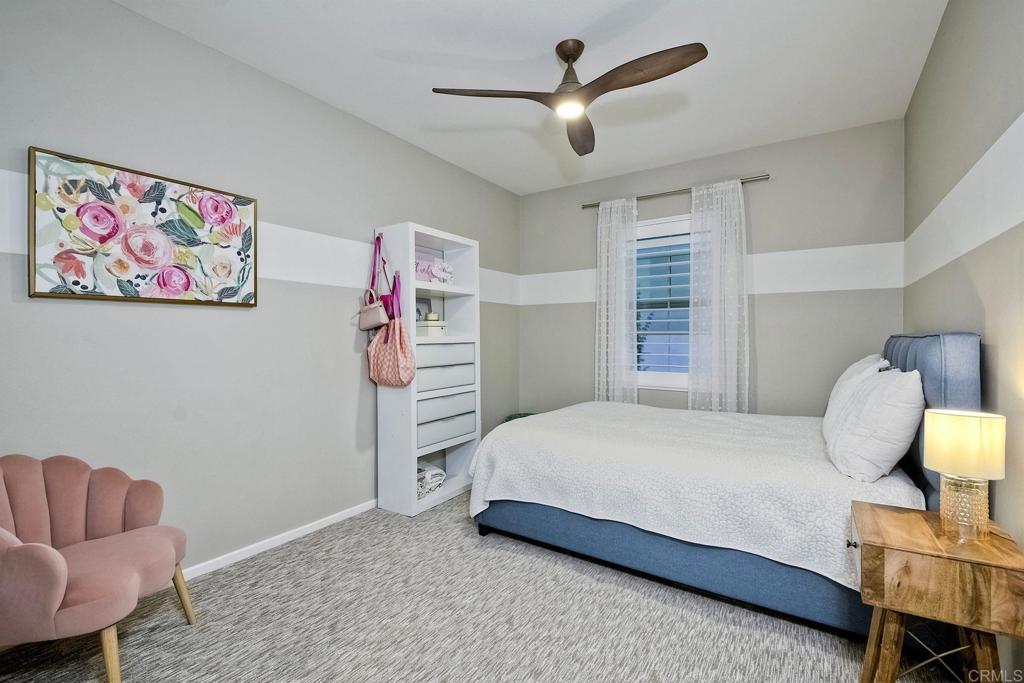 663 Gemstone Drive San Marcos, CA 92078 - Photo 24 of 38 a bedroom with a bed and furniture