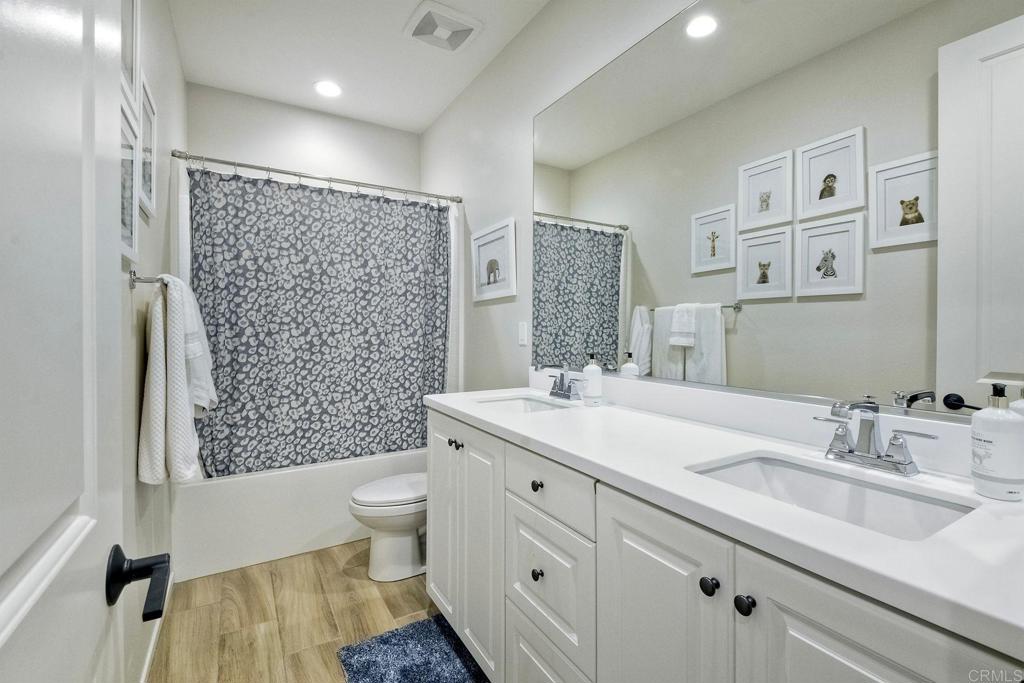 663 Gemstone Drive San Marcos, CA 92078 - Photo 26 of 38 a bathroom with a sink a toilet and shower