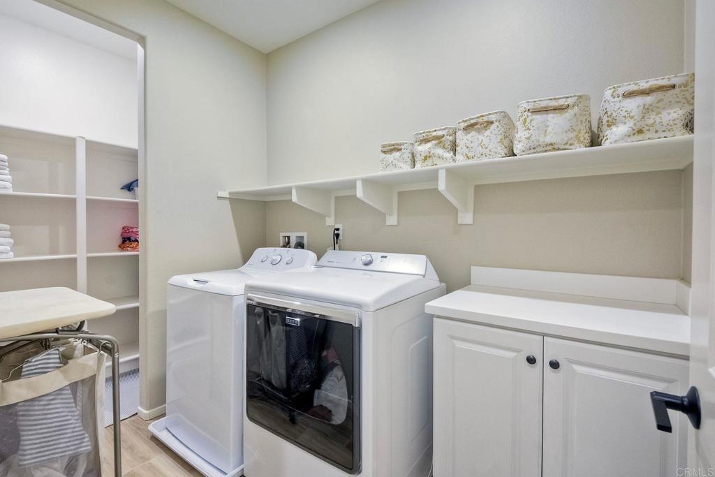 663 Gemstone Drive San Marcos, CA 92078 - Photo 27 of 38 a utility room with cabinets washer and dryer
