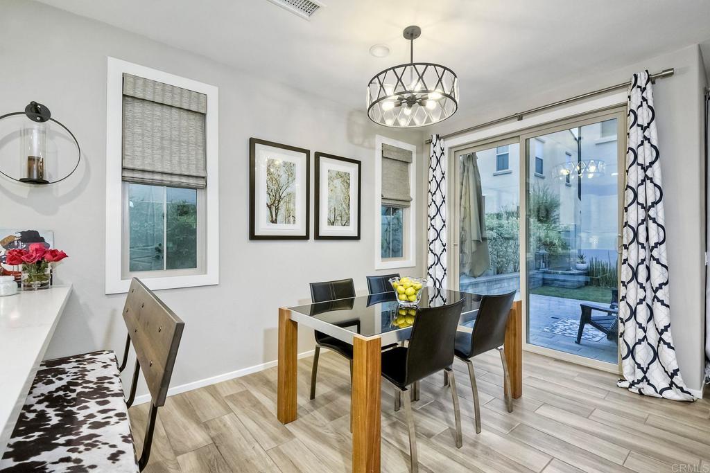 663 Gemstone Drive San Marcos, CA 92078 - Photo 10 of 38 a view of a dining room with furniture wooden floor and chandelier