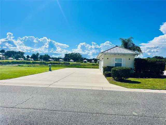 a front view of a house with yard and green space