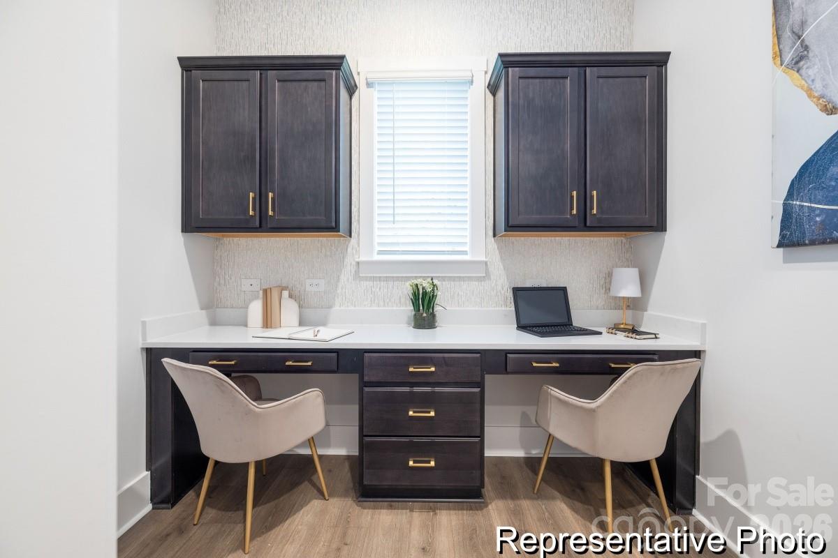 106 West Rice Planters Way, Unit 8P Statesville, NC 28625 - Photo 13 of 35 a kitchen with a sink and wooden cabinets