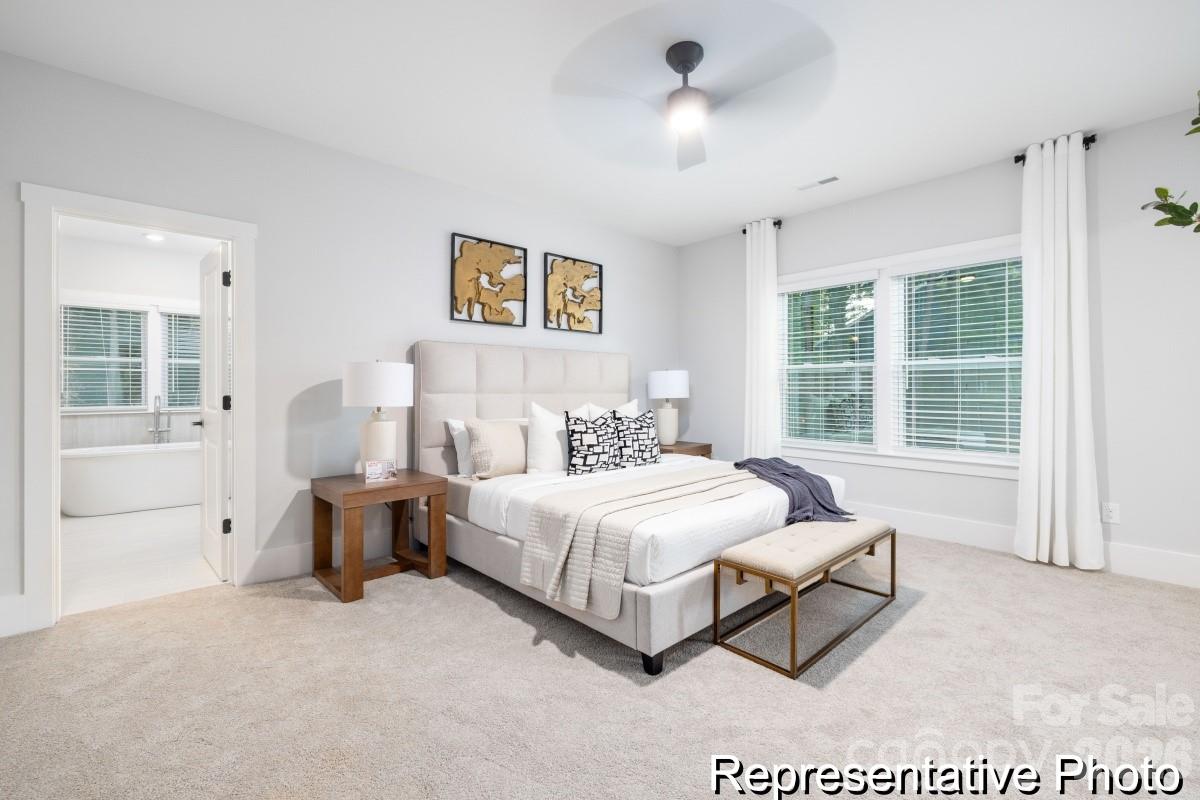 106 West Rice Planters Way, Unit 8P Statesville, NC 28625 - Photo 20 of 35 a spacious bedroom with a bed and a large window