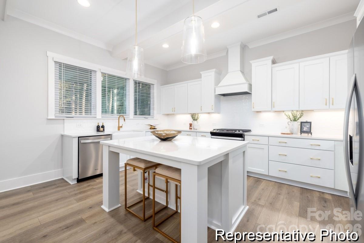 106 West Rice Planters Way, Unit 8P Statesville, NC 28625 - Photo 2 of 35 a kitchen with a sink stove and cabinets