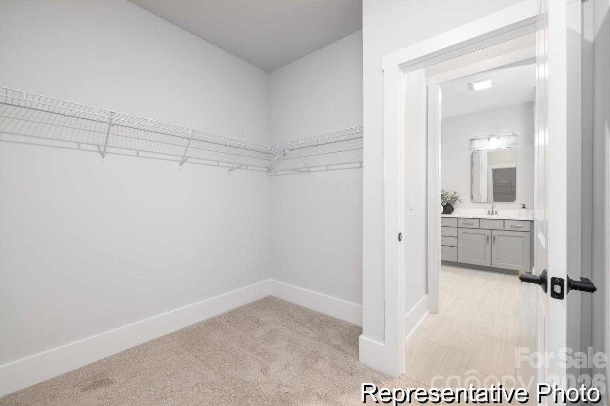 106 West Rice Planters Way, Unit 8P Statesville, NC 28625 - Photo 25 of 35 a bathroom with a sink a mirror and a shower