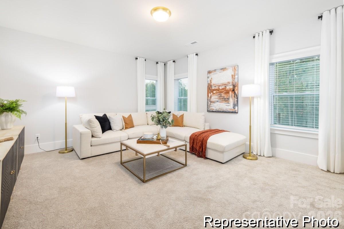 106 West Rice Planters Way, Unit 8P Statesville, NC 28625 - Photo 32 of 35 a spacious bedroom with a bed and a couch