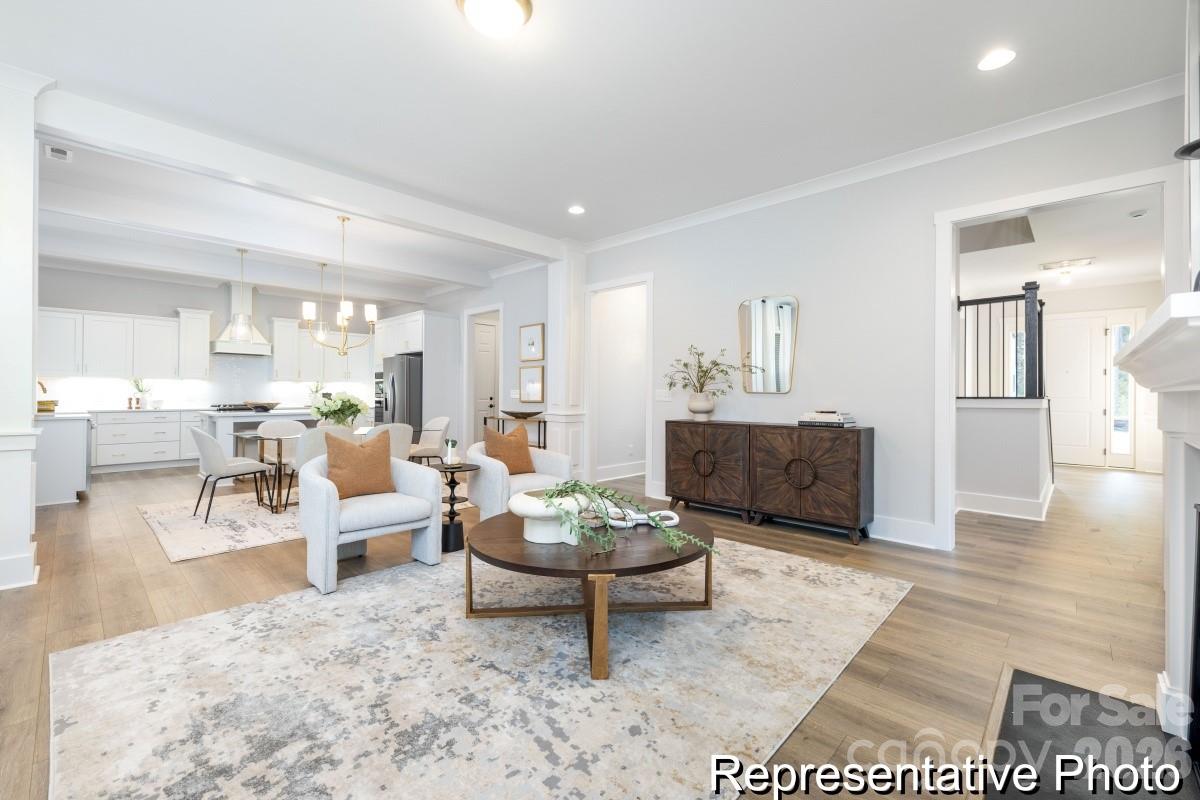 106 West Rice Planters Way, Unit 8P Statesville, NC 28625 - Photo 9 of 35 a living room with furniture and a wooden floor