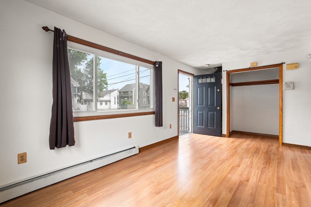 23 Logan Street Lynn, MA 01902 - Photo 13 of 27 a view of empty room with wooden floor and fan