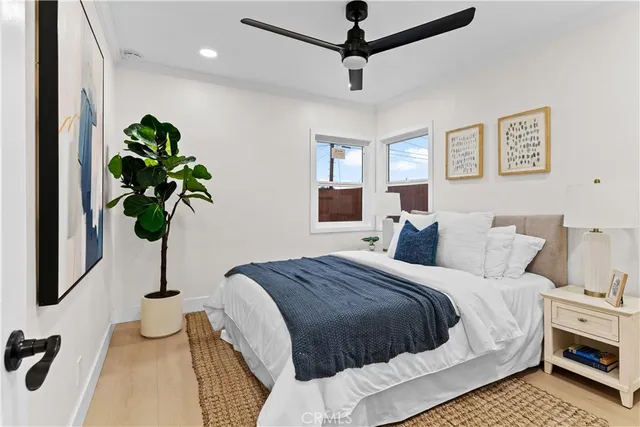 a bedroom with a bed and a potted plant