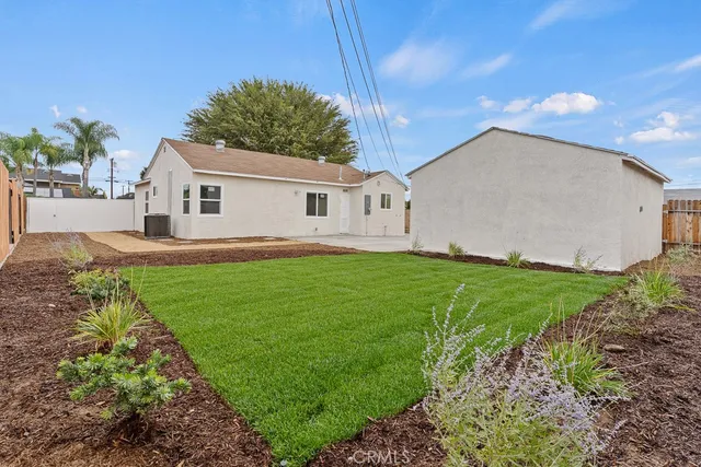 a view of a house with a yard and plants