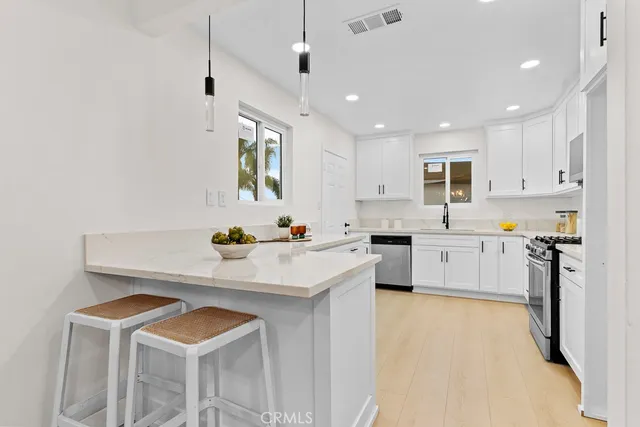 a kitchen with a sink stove and refrigerator