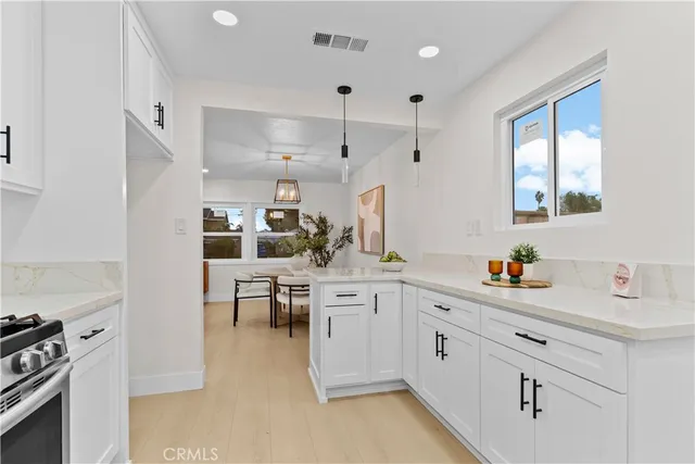a kitchen with white cabinets and white appliances