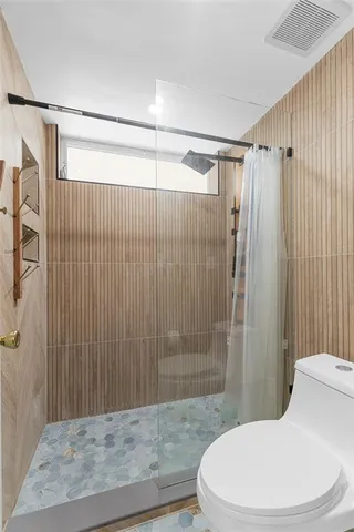a bathroom with a toilet and shower