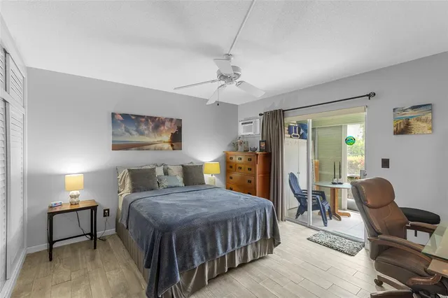 a bedroom with a bed a chandelier and a dresser