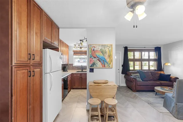 a living room with furniture a fireplace and a chandelier