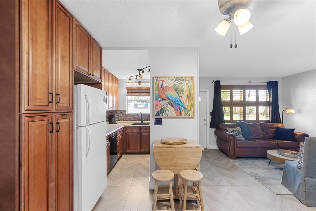 30 Southeast 13th Street, Unit A6 Boca Raton, FL 33432 - Photo 4 of 30 a living room with furniture a fireplace and a chandelier