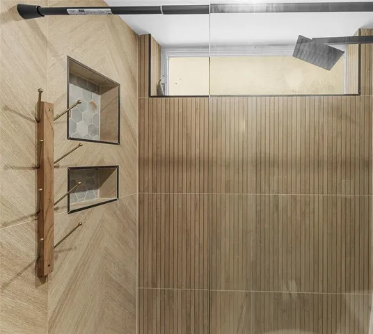 a view of bathroom with small shower